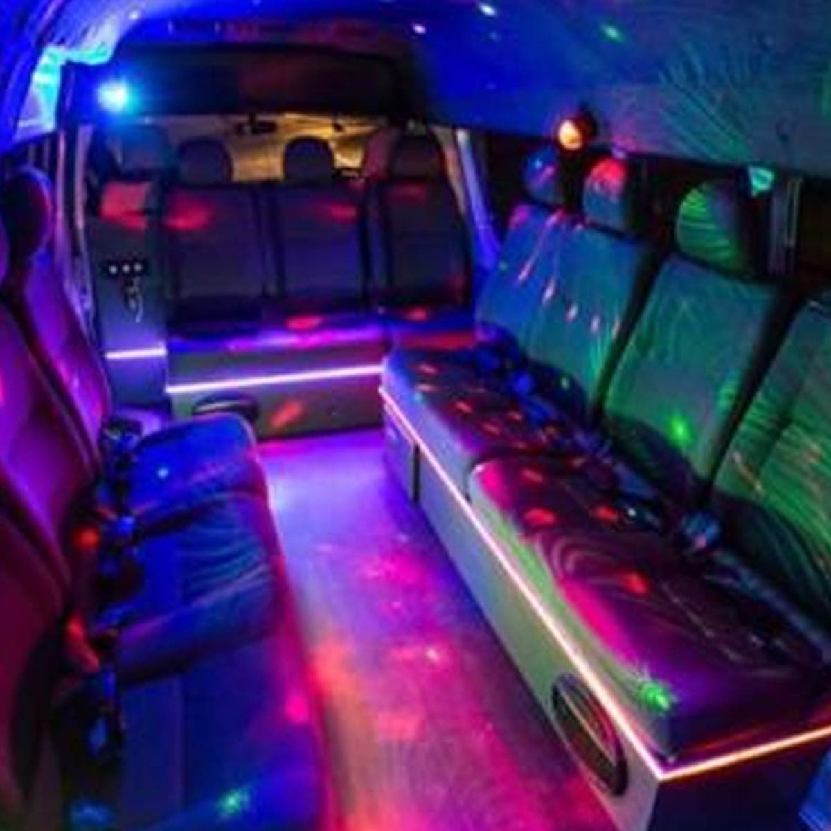 Bench seating and the lit aisle of the 14 seater party limo